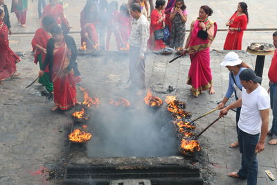 Group of people by bonfire during festival