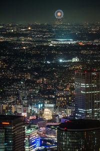 High angle view of illuminated buildings in city at night