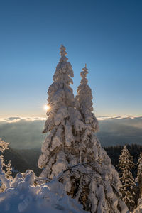 Snowcapped mountains against clear sky during winter