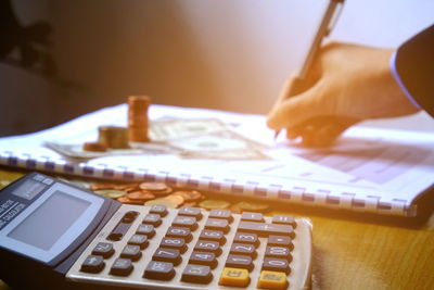 Close-up of hand using laptop on table