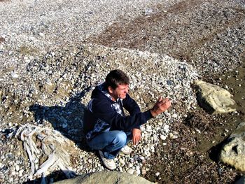 High angle view of man on rock at beach