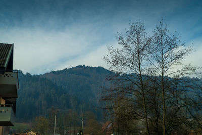 Scenic view of trees and mountains against sky