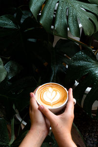 Midsection of man holding coffee cup
