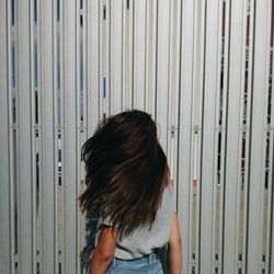 Woman standing against wall