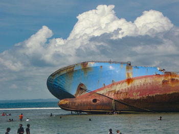 People on beach against sky