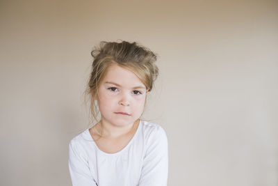 Portrait of a young girl looking at the camera with a serious face