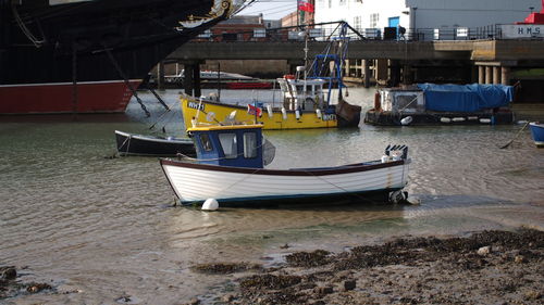 Boats moored at harbor