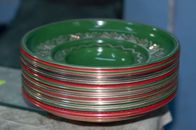 Close-up of colorful plates stacked on table