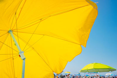 Parasol at beach on sunny day