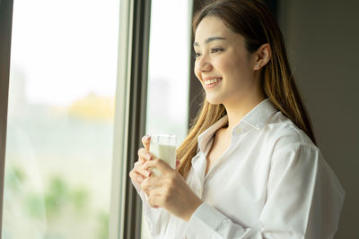 Portrait of young businesswoman using mobile phone