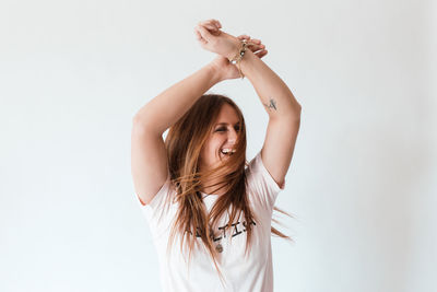Portrait of young woman against white background