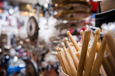 Close-up of wooden drumsticks in shop for sale