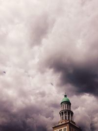 Low angle view of built structure against cloudy sky