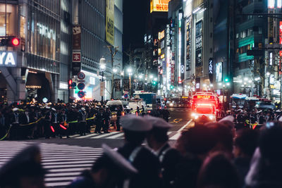 Crowd on street in city at night