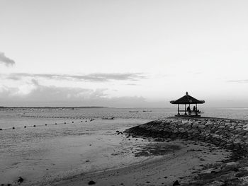 Lifeguard hut on beach against sky