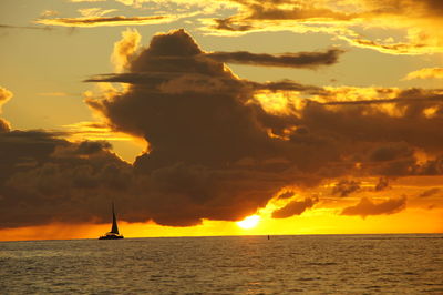 Scenic view of sea against orange sky