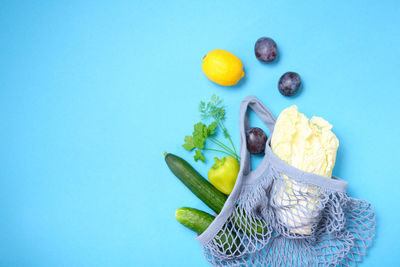 Fruits in basket against blue background