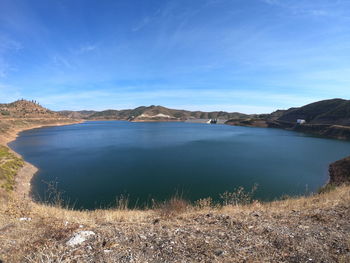 Scenic view of lake against blue sky