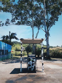 Built structure by trees against sky