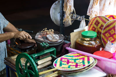 Dried squid roasting on charcoal stove before grind until tender. famous thai street food.