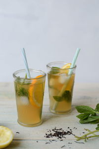 View of glasses of iced tea with mint and sliced lemon