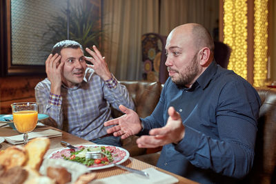 Man and woman sitting on table