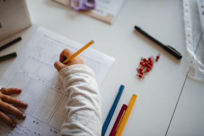 High angle view of girl doing homework