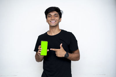 Portrait of a smiling young man against white background