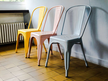 Empty chairs against tiled floor