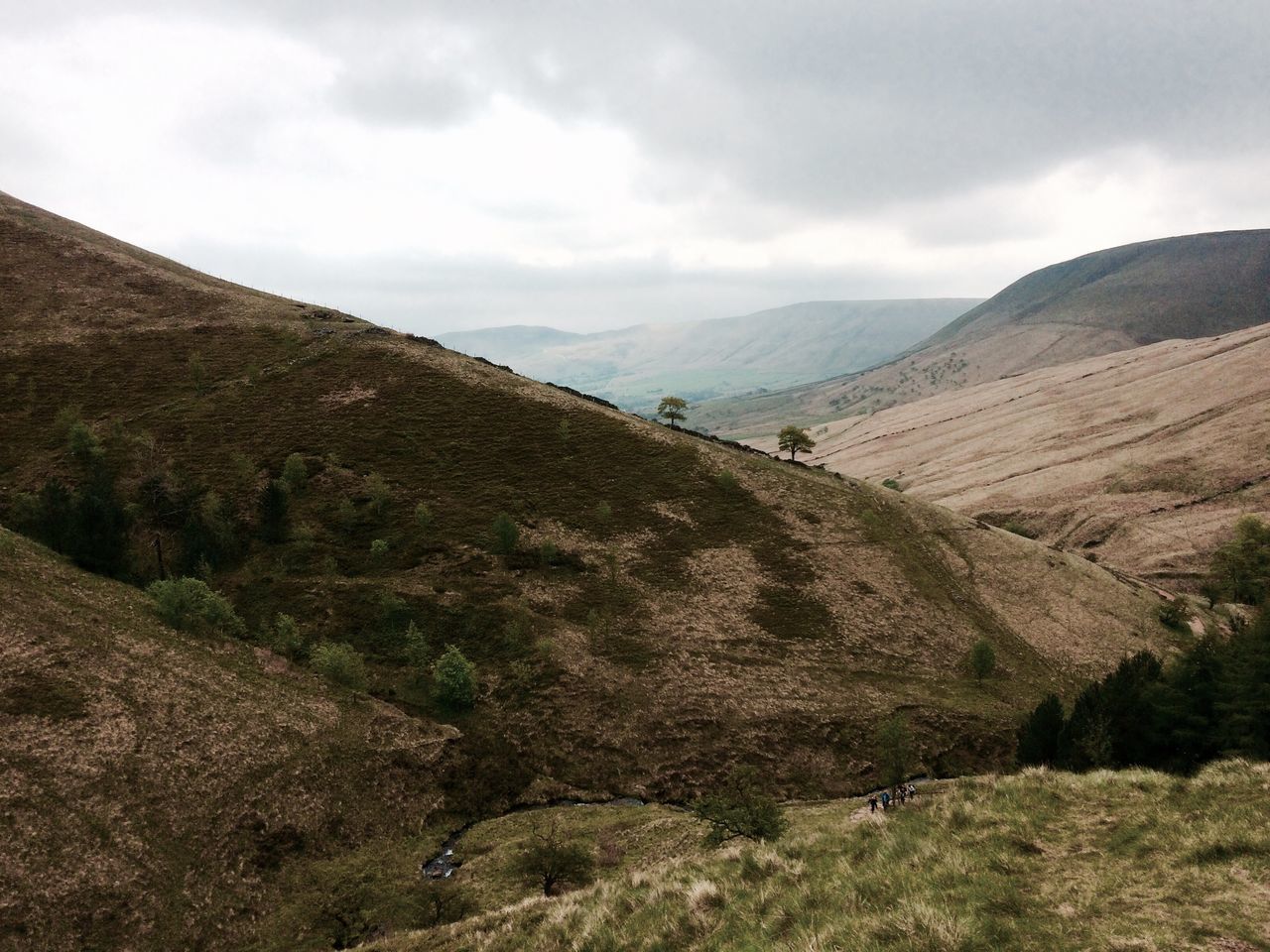 mountain, tranquil scene, mountain range, sky, tranquility, landscape, scenics, beauty in nature, cloud - sky, nature, non-urban scene, cloud, cloudy, grass, remote, idyllic, valley, physical geography, hill, day