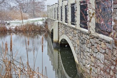 Reflection of trees on snow covered canal