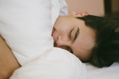 Portrait of woman sleeping on bed