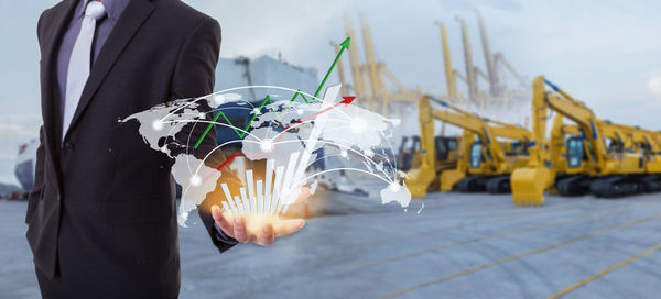 Digital composite image of businessman with world map at dock