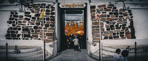 Rear view of people standing outside building