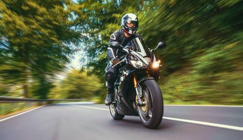 Man riding motorcycle on road