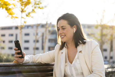 Portrait of young woman using mobile phone