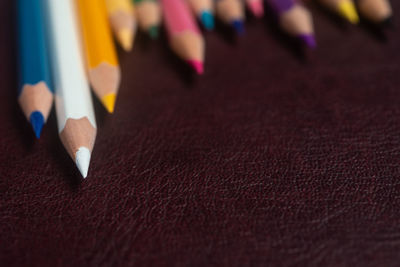 Close-up of multi colored pencils on table-