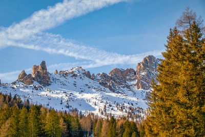 A sky cross made of clouds over the italian dolomites in autumn