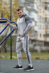 Full length of young man standing in city