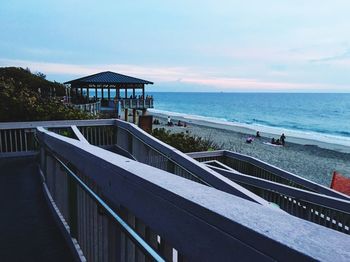 Scenic view of beach against cloudy sky