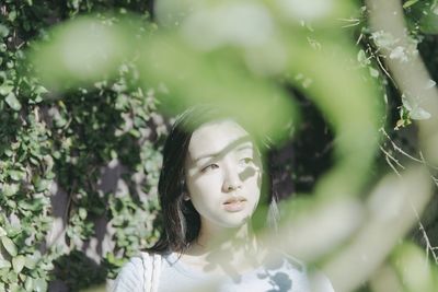 Beautiful woman seen through plants