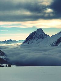 Scenic view of snowcapped mountains against sky during sunset