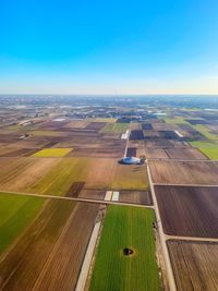 Aerial view of agricultural field against sky