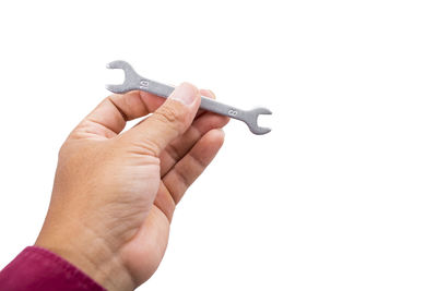 Close-up of hand holding stick against white background