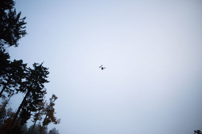 Low angle view of airplane flying against clear sky