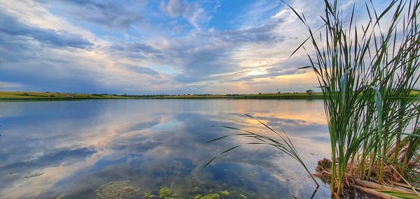Scenic view of lake against sky during sunset