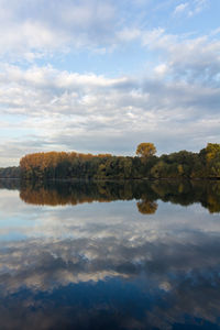 Reflection of trees in lake against sky