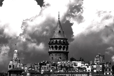 Low angle view of built structure against cloudy sky