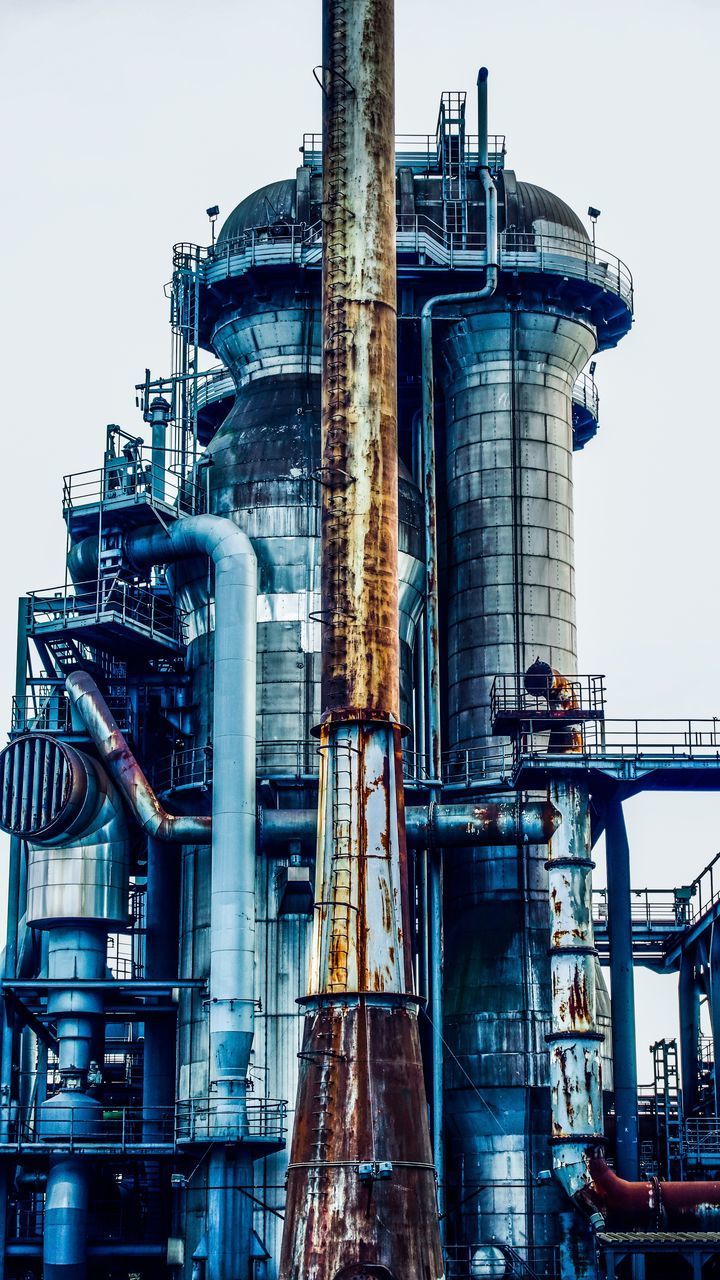 LOW ANGLE VIEW OF SMOKE STACKS AGAINST SKY