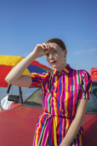 Full length of teenage girl looking away against sky